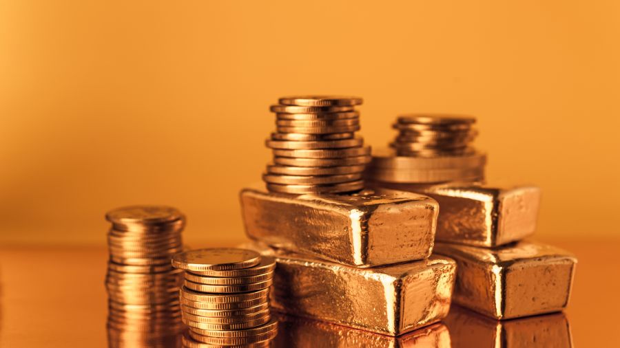 Gold bars and stack of gold coins. Background for finance banking concept. Trade in precious metals.